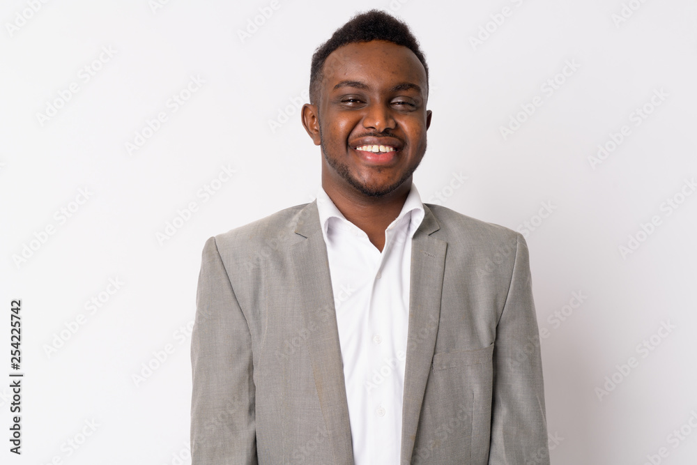 Portrait of happy young African businessman in suit smiling Portrait of happy young African businessman in suit smiling