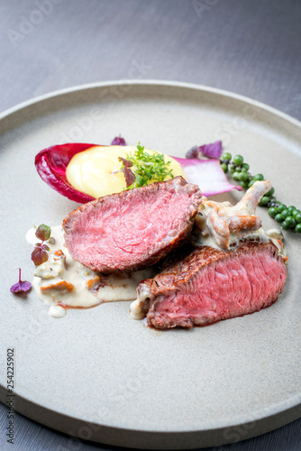 Barbecue wagyu point steak from beef sliced with chanterelle and mashed potatoes as top view on a modern design plate