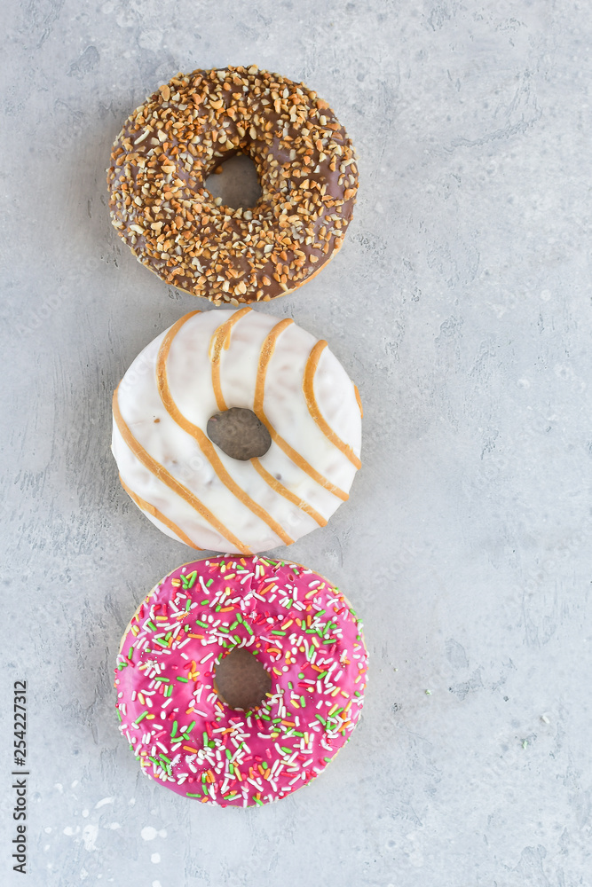 a large Cup of cappuccino coffee and colorful donuts, on the Cup inscription in French (mocha coffee, coffee with milk). light background, selective focus, without logo a large Cup of cappuccino coffee and colorful donuts, on the Cup inscription in French (mocha coffee, coffee with milk). light background, selective focus, without logo
