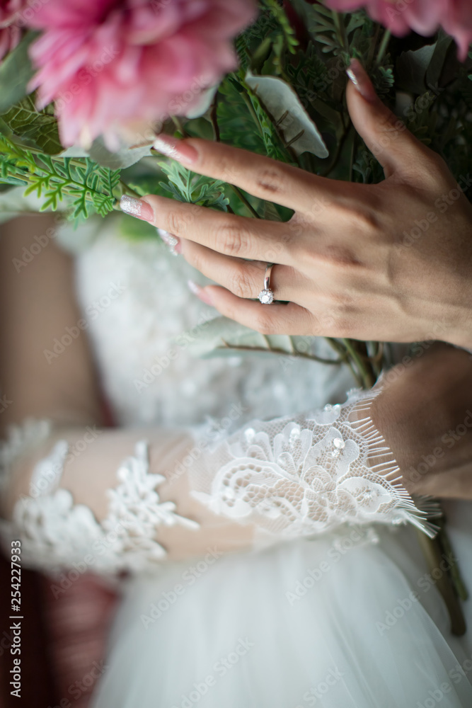 Bride's hands with flowers . bouquet in hands of the bride, woman getting ready before wedding ceremony .