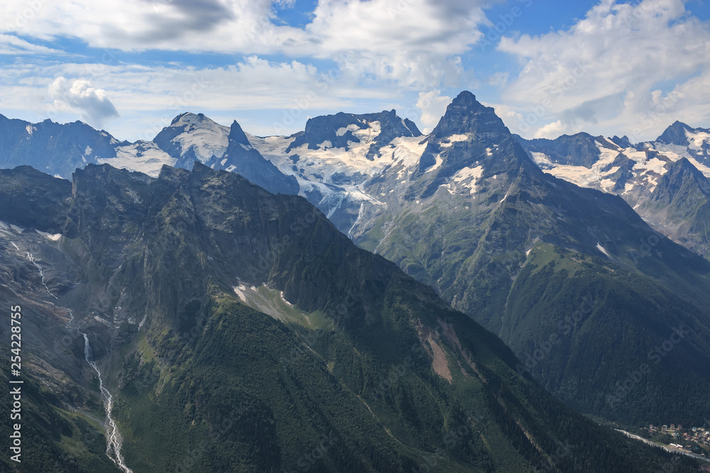 Panorama of mountains scene with dramatic blue sky in national park of Dombay