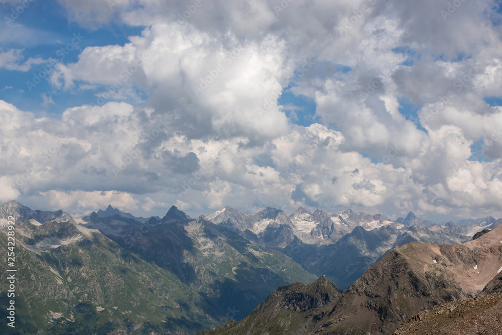 Panorama of mountains scene with dramatic cloudy sky in national park of Dombay