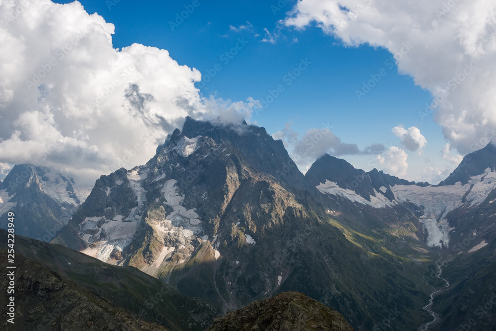 Panorama of mountains scene with dramatic blue sky in national park of Dombay