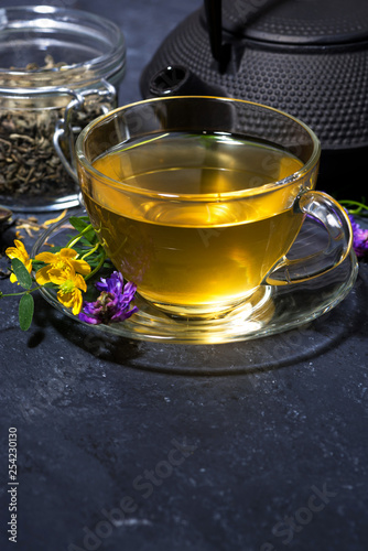 tea with aromatic herbs on a dark background, vertical © cook_inspire
