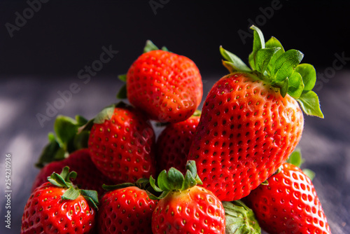 Strawberries on dark wooden background