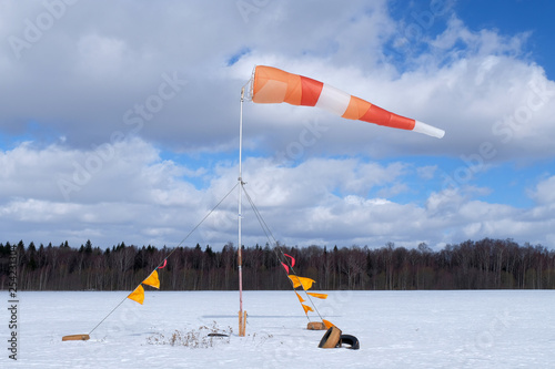 A windsock is on the snowy field. photo