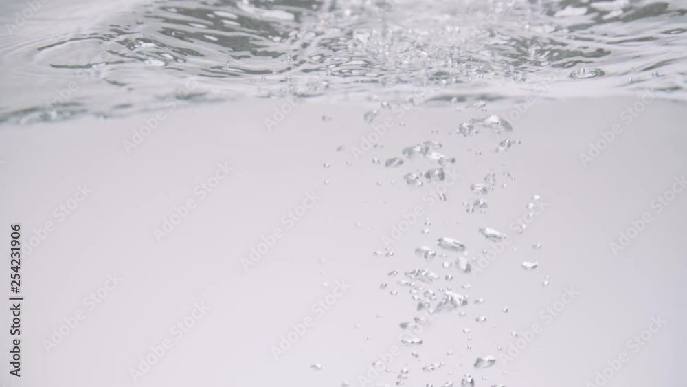 Tomatoes splashing into water with a white backdrop. Tomatoes splashing into water with a white backdrop.