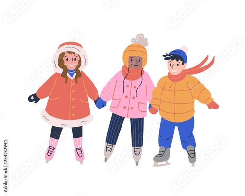 Happy little children skating on ice rink and having fun