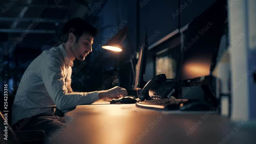 Overtime Work In Office.Man Working On Modern Office At Night.Overworked Businessman Working Late At Night, Alone In The Office.Exhausted Businessman Working Late At The Office.Man Working Late Night. Overtime Work In Office.Man Working On Modern Office At Night.Overworked Businessman Working Late At Night, Alone In The Office.Exhausted Businessman Working Late At The Office.Man Working Late Night.