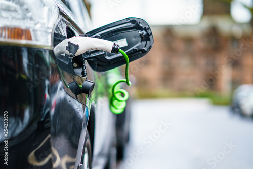 Electric Vehicle is changing in street.