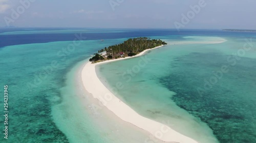 Incredible beauty of Panampangan island near Tawi Tawi, Philippines with its long white strip of sandy beach splitting the clear warm water. Relaxing solitude of a tiny tropical island. Aerial view. photo