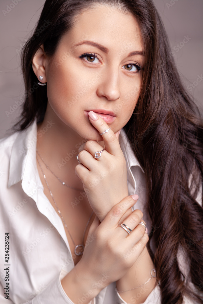 Closeup beautiful brunette girl with long hair in silver jewelry earrings, rings, bracelet and necklace in decollete. Сoncept gentle, elegant, delicate, romantic jewelry, bijouterie on model Closeup beautiful brunette girl with long hair in silver jewelry earrings, rings, bracelet and necklace in decollete. Сoncept gentle, elegant, delicate, romantic jewelry, bijouterie on model