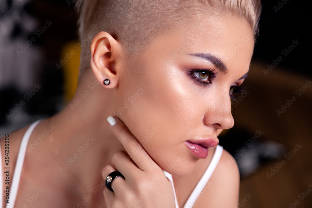 Closeup portrait sexy blonde model with bright make-up and short hair with  shaved temples in modern round black silver jewelry, earrings, rings,  bracelet, necklace. Сoncept fashion shooting Stock Photo | Adobe Stock