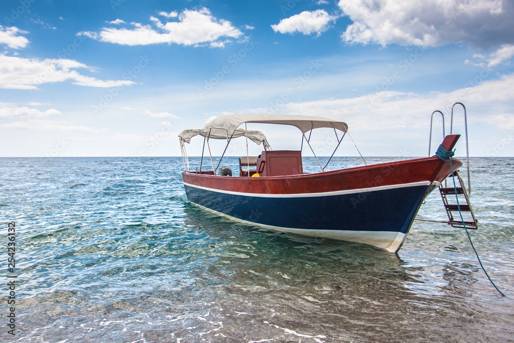 Fototapeta premium Wooden boat on the sicilian beach, Italy