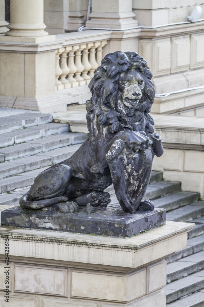 bronze statue of a lion on a pedestal