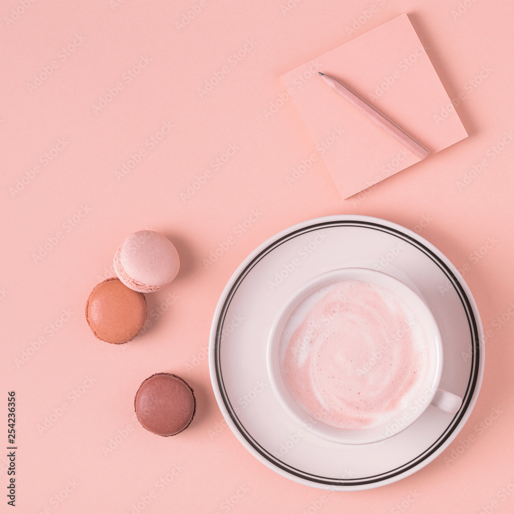Cup of coffee with macaroons on pastel background. Cup of coffee with macaroons on pastel background.