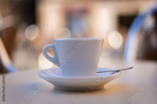 Cup of coffee on a bar table with unfocused background