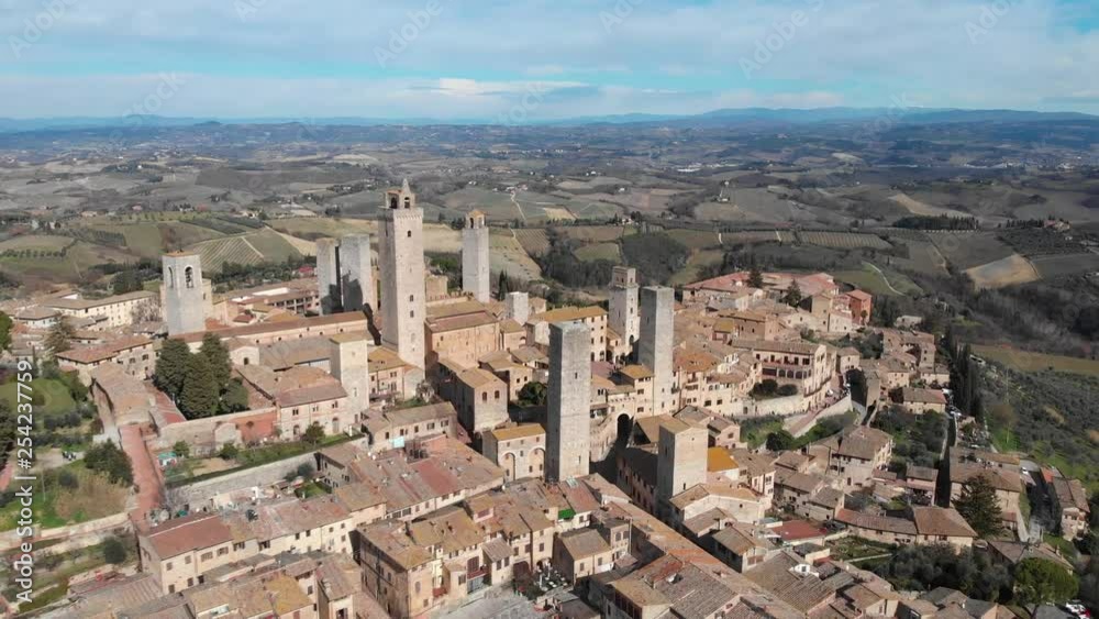Flying over a typical medieval tuscan village, San Gimignano. Italy, Tuscany, San Gimignano. Aerial landscape. Flying over a typical medieval tuscan village, San Gimignano. Italy, Tuscany, San Gimignano. Aerial landscape.