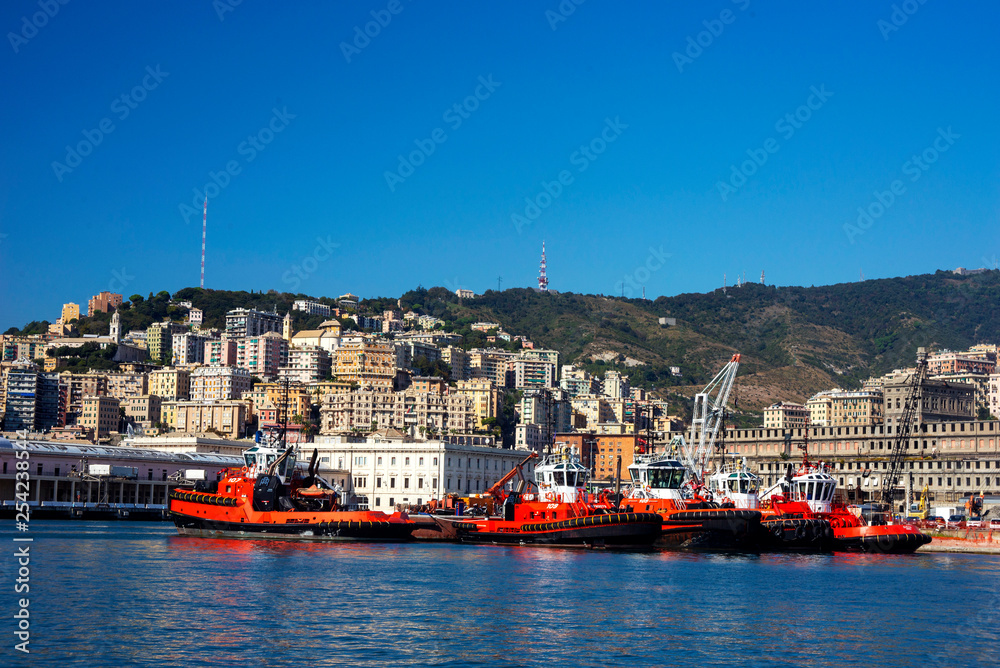  Beautiful view of the rocky mountains, the Italian city of Genoa, the port and the red boats. Blue sky with white cloud. Blue Ocean.