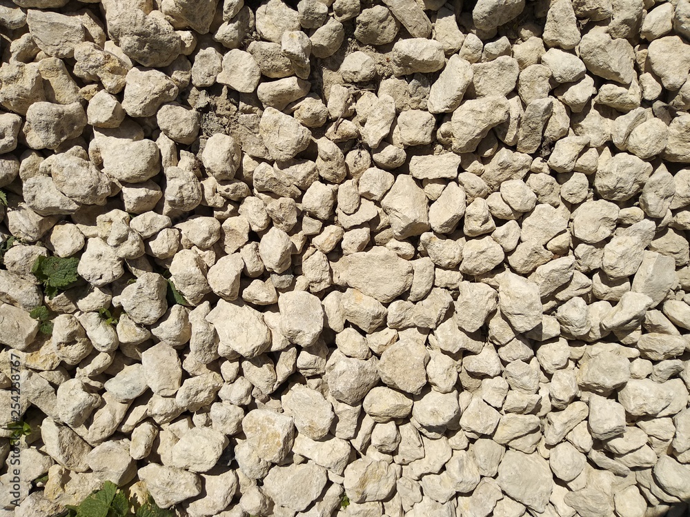 photo of white textured stones with sharp edges on a bright Sunny day photo of white textured stones with sharp edges on a bright Sunny day