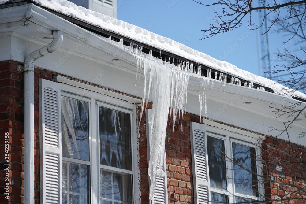 icicle on the house roof in winter season - obrazy, fototapety, plakaty 