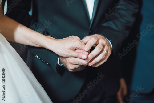 Bride and groom holding hands in church