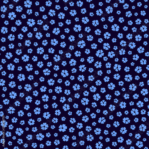 Seamless ditsy floral pattern in vector. Small blue flowers on a dark blue background.	