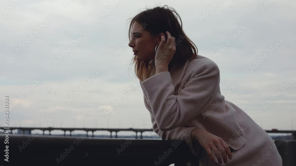 Woman looking forward at river thinking and dreaming outdoors over sky background Woman looking forward at river thinking and dreaming outdoors over sky background