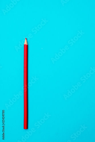 Red pencil on blue background