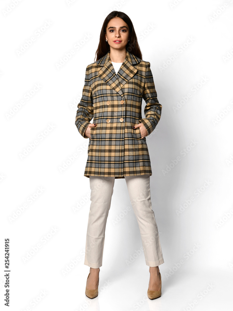 Young beautiful woman posing in new spring fashion casual green yellow grey jacket coat hat full body Young beautiful woman posing in new spring fashion casual green yellow grey jacket coat hat full body