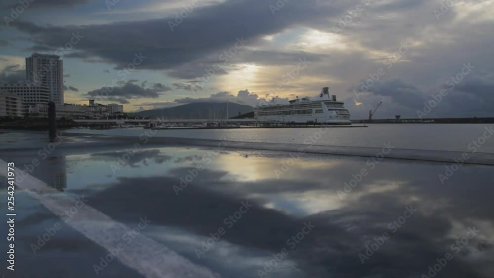 Early morning view of the sea port and marina of Ponta Delgada on the island of Sao Miguel of the Portuguese Azores. Tracking shot from a balcony. Early morning view of the sea port and marina of Ponta Delgada on the island of Sao Miguel of the Portuguese Azores. Tracking shot from a balcony.