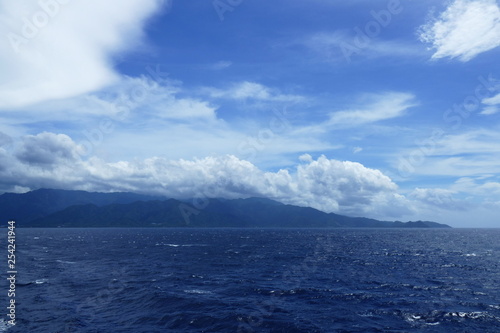 Island of Yakushima covered in clouds and seen from a ship