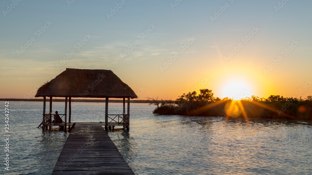 Sunrise, meditation in the lagoon of the seven colors, in Bacalar, Quintana Roo, Mexico.