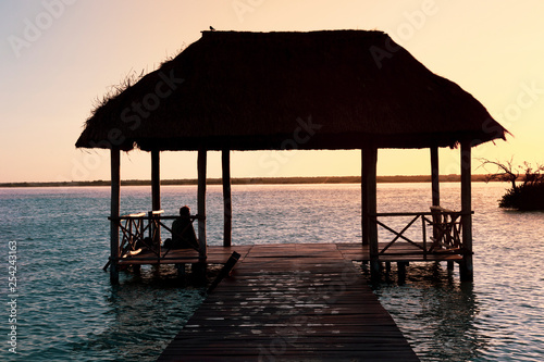 Sunrise  meditation in the lagoon of the seven colors  in Bacalar  Quintana Roo  Mexico.