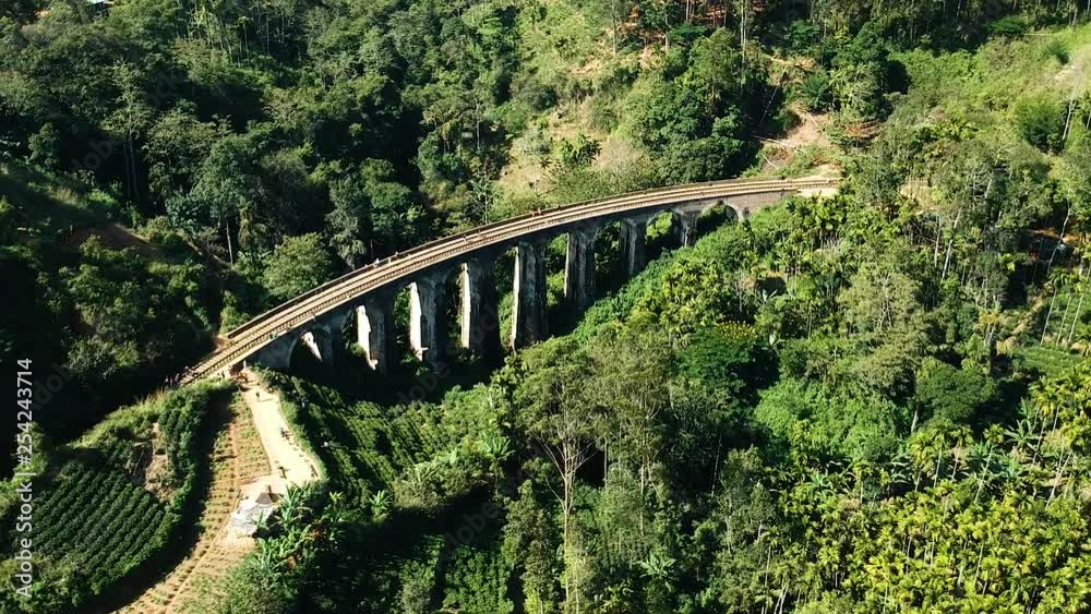 Aerial of famous nine arch bridge in Ella, Sri Lanka with blue train Aerial of famous nine arch bridge in Ella, Sri Lanka with blue train