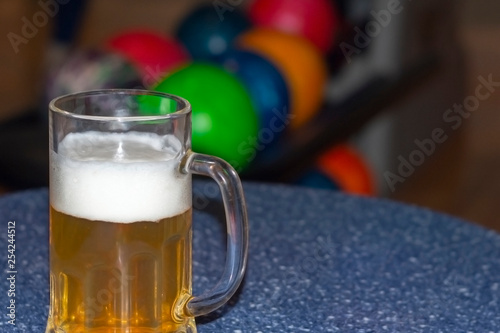 Mug of beer on the table in the bowling center