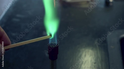 Close up of blue bunsen burner flame followed by copper flame test burning green