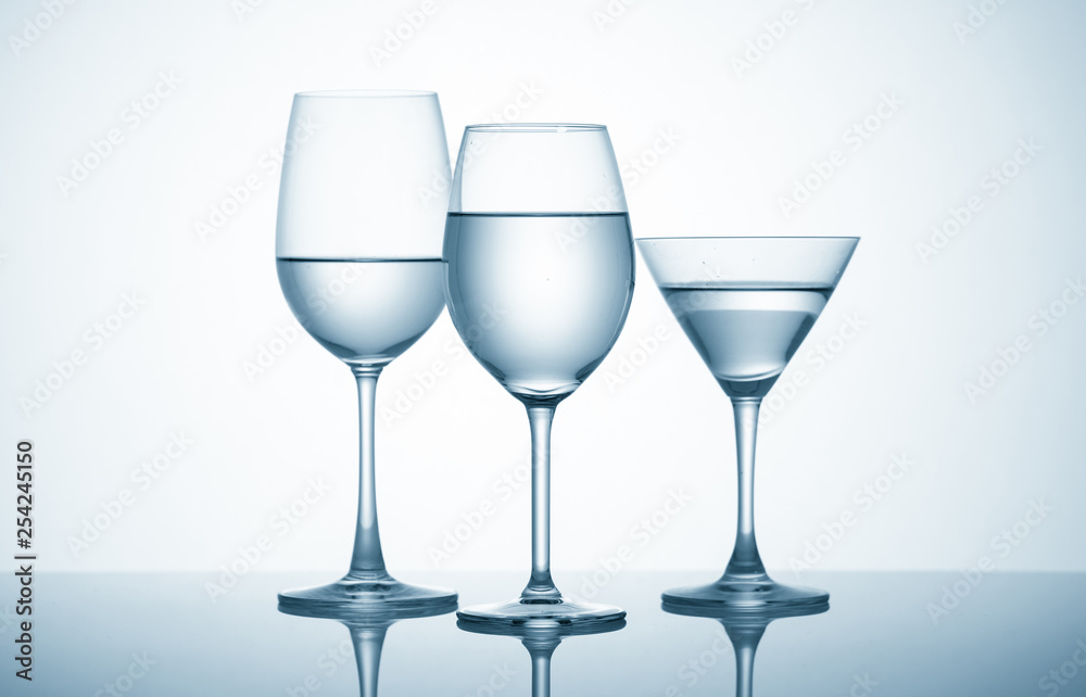 Glasses with water on blue background