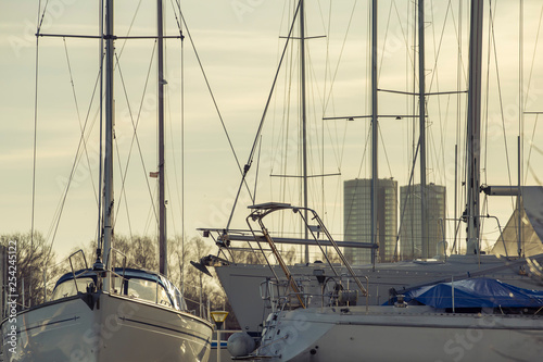 Yacht masts and various yachts on city center on the background © juriskraulis