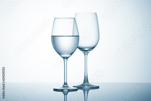 Glasses with water on blue background