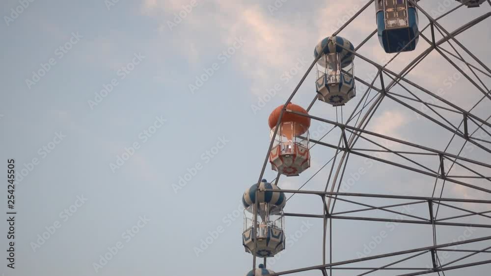 Slow rotation of a ferris wheel on a cloudy day Slow rotation of a ferris wheel on a cloudy day