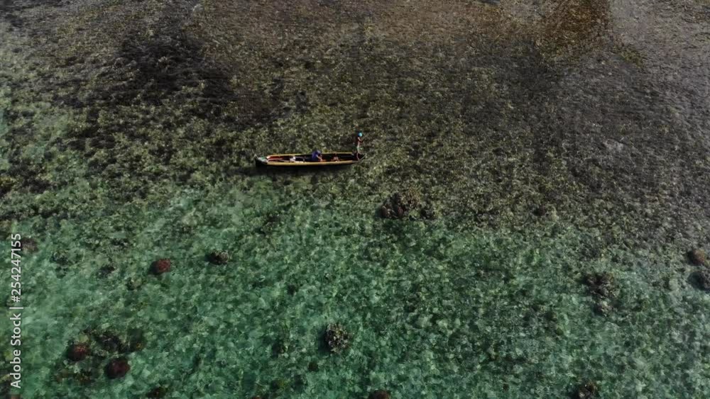 aerial view local Guna poles canoe over reef in San Blas Islands archipelago Panama aerial view local Guna poles canoe over reef in San Blas Islands archipelago Panama
