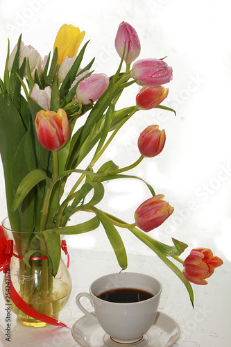 cup of coffee and a bouquet of flowers on a white background, a beautiful morning and the arrival of spring
