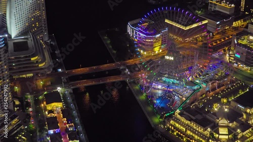 Zoom out of Minato Mirai with Cosmo Clock 21 Ferris Wheel at night with lights in Yokohama, Japan photo