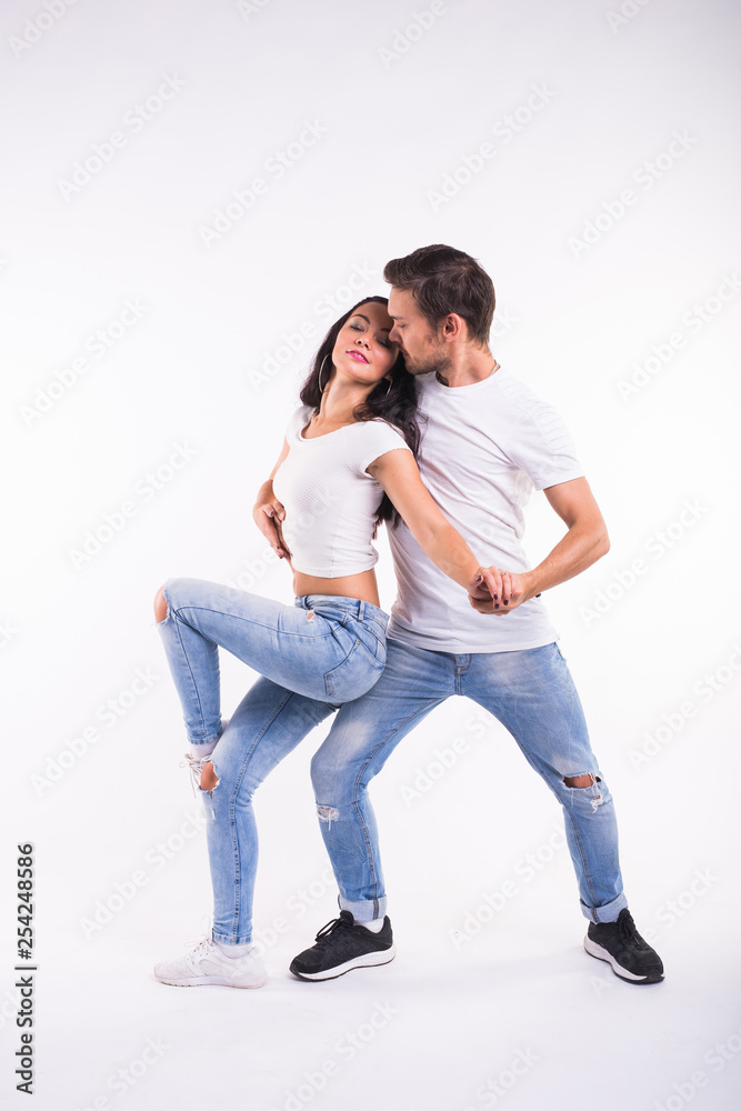 Passionate couple dancing social danse kizomba or bachata or semba or taraxia on white background Passionate couple dancing social danse kizomba or bachata or semba or taraxia on white background