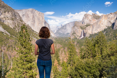 Young woman is looking at Yosemite valley from Tunnel View in Yosemite National park, United states of America