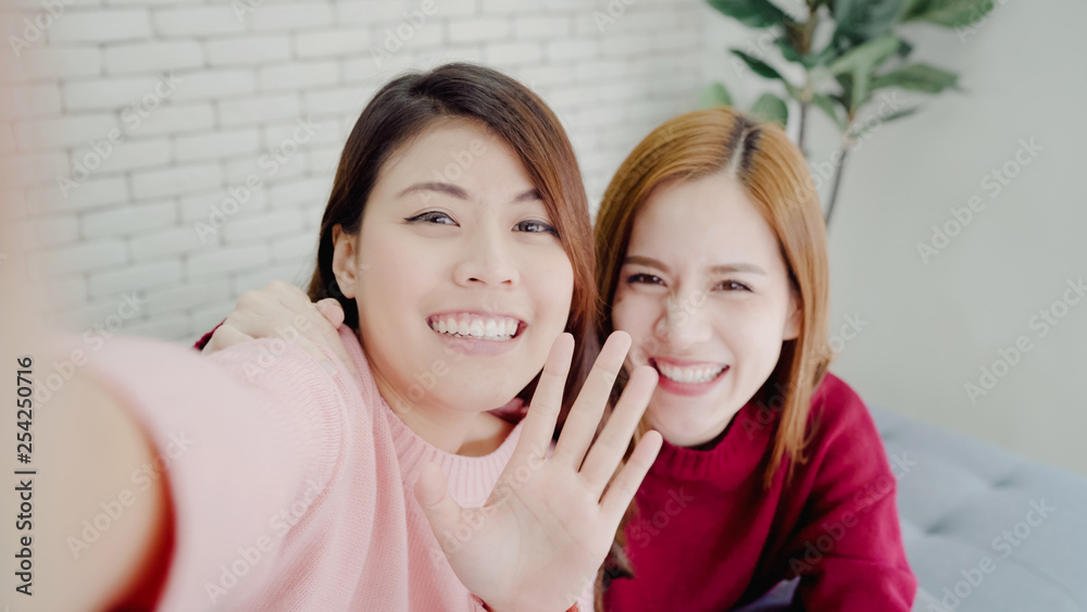 Asian blogger women using smartphone selfie and recording vlog video in living room at home, group of friend enjoy funny moment while lying on the sofa when relax at home. Point of view. Asian blogger women using smartphone selfie and recording vlog video in living room at home, group of friend enjoy funny moment while lying on the sofa when relax at home. Point of view.