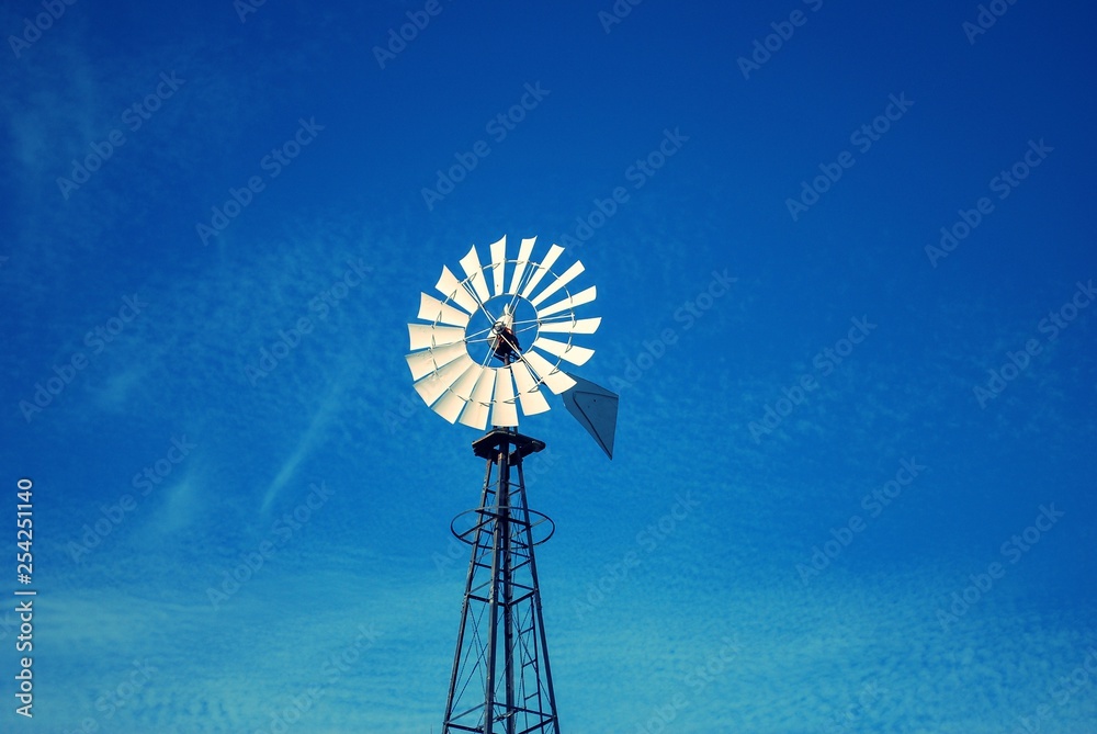 Upshot of Windmill with blue sky and clouds Upshot of Windmill with blue sky and clouds