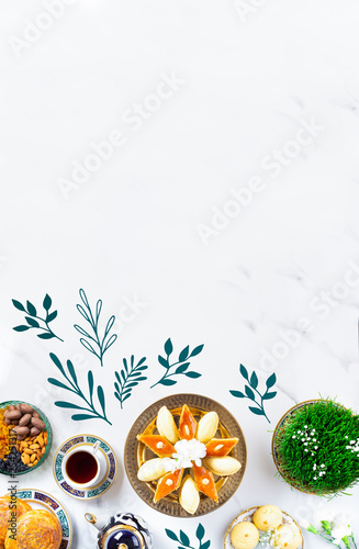 Novruz Azerbaijan traditional table setting, delicious sweet pastry on white oriental background with tea cup, teapot, green wheat grass semeni, plate of pakhlava and shekerbura and gogal, copy space
