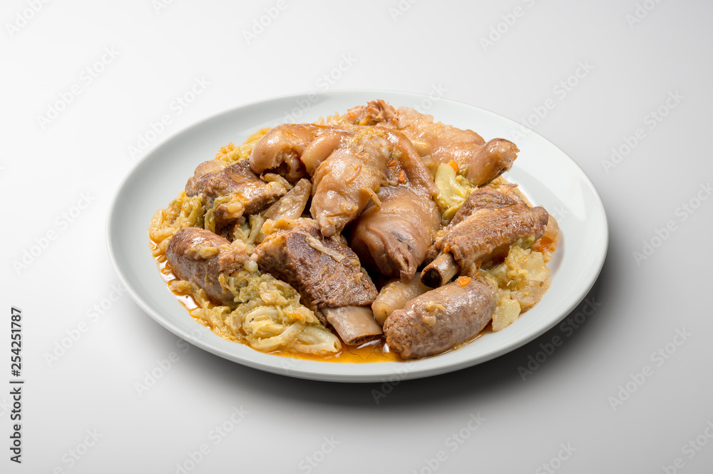 White plate with pork meat and savoy cabbage White plate with pork meat and savoy cabbage